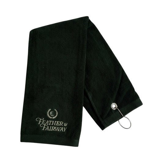 Dark green golf towel with 'Feather & Fairway' branding on a white background