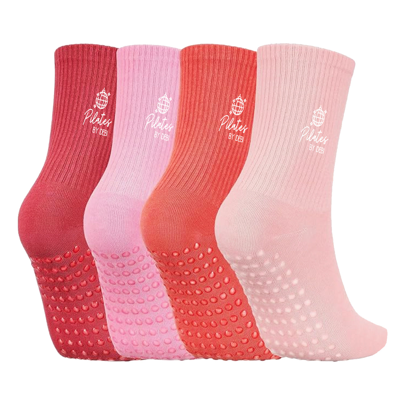 Four pairs of red and pink socks with textured soles and white Pilates by Debi logo on a white background.